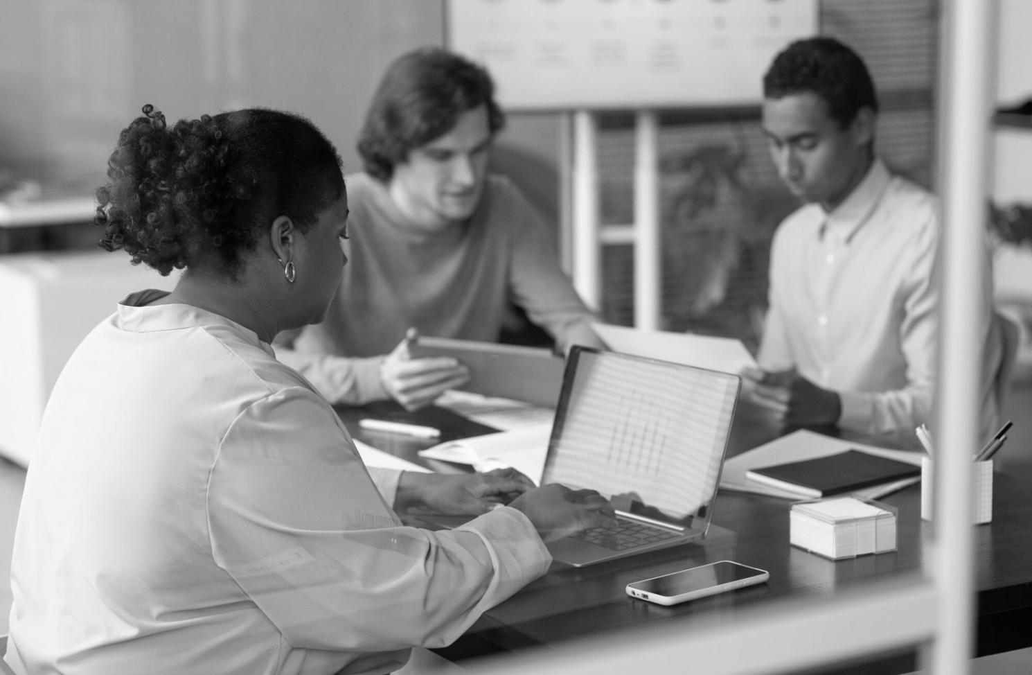 Team collaboration session with financial planning materials and charts