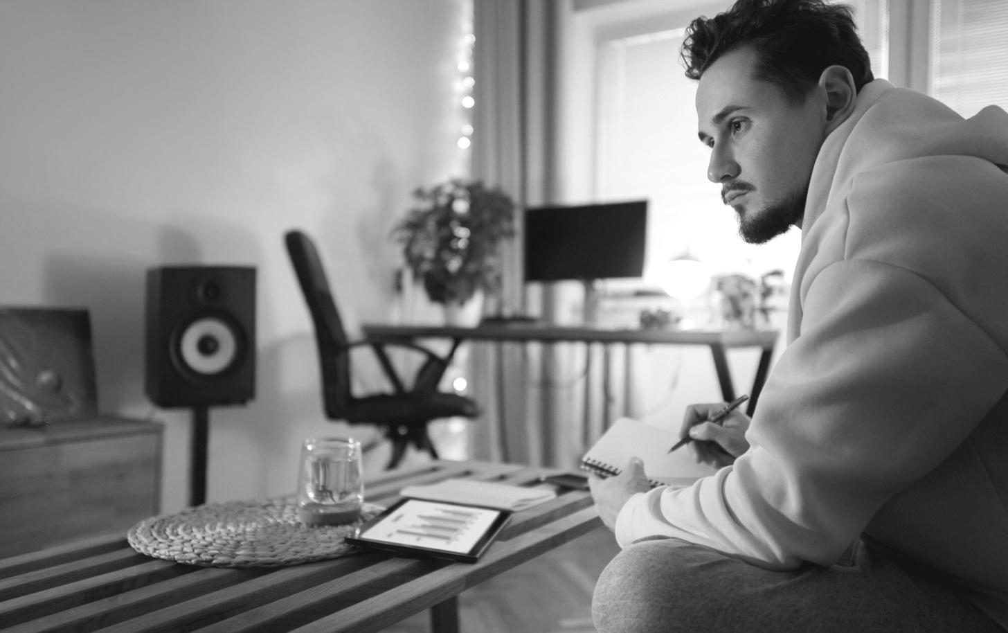 Person reviewing budget progress with satisfaction, showing successful financial planning